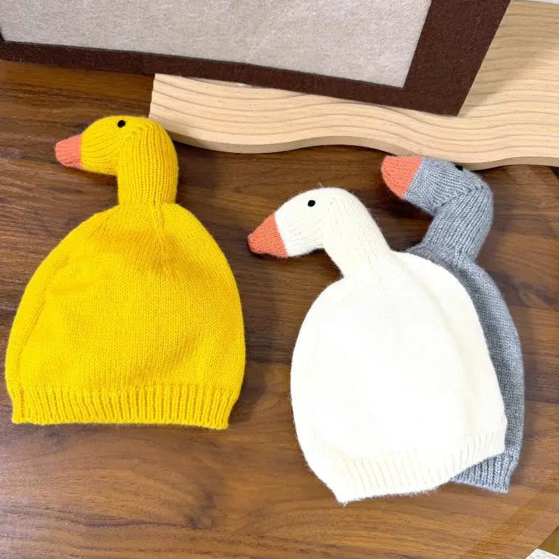 Duck knit beanies flat on wood